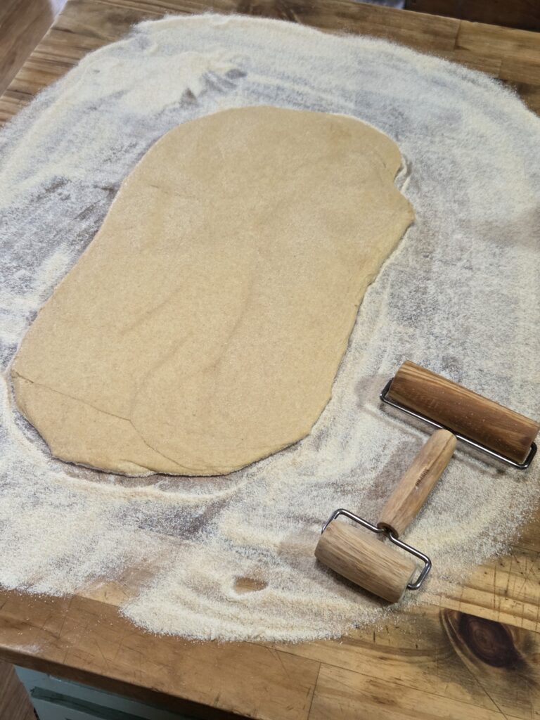 rolling out English muffins dough
