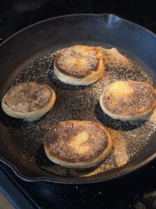 cooking english muffins on a cast-iron