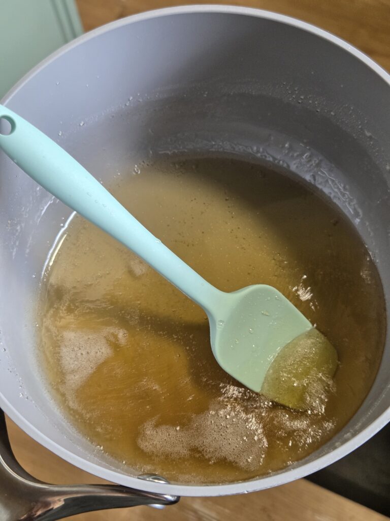 heating sugar, water, and corn syrup in a pan