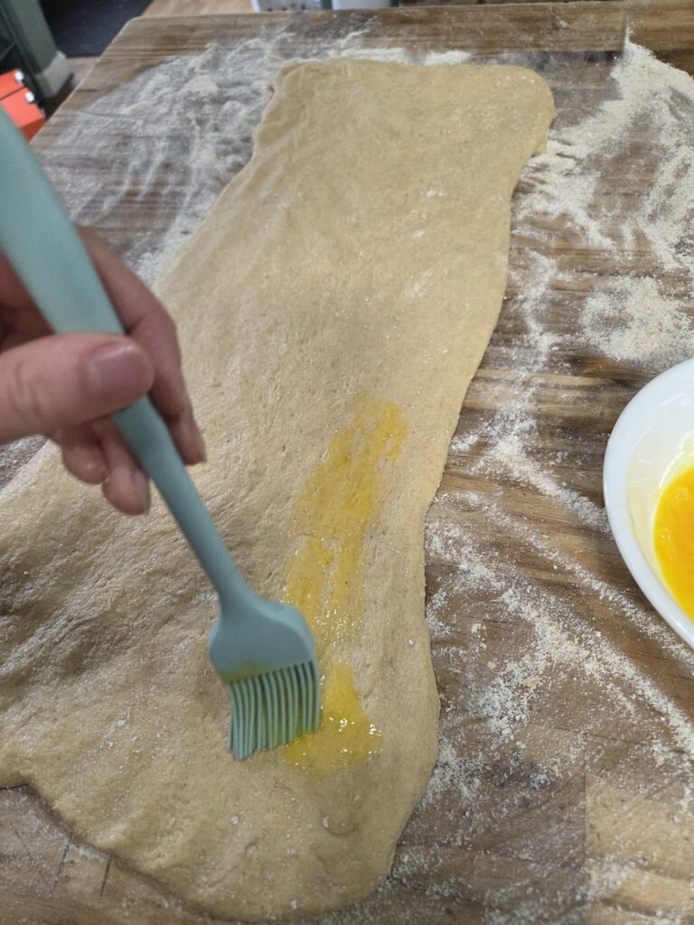 putting egg on the dough
